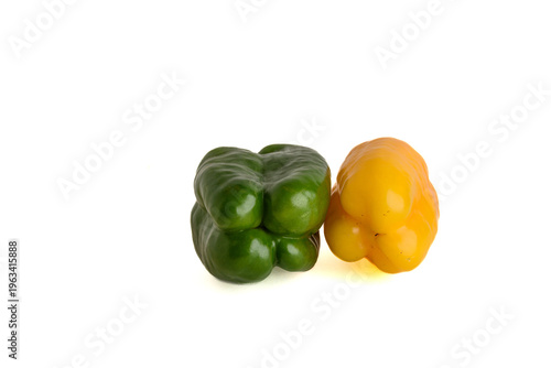 Green And Yellow Bell Peppers On White Background Fresh Raw Vegetables Close-Up Studio Photo