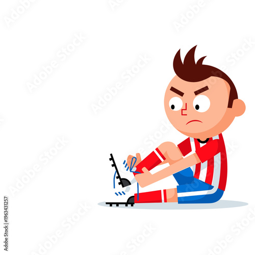 Soccer player sits on ground clutching injured ankle in pain outdoors