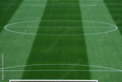 Background Texture of International-Standard Football Pitch with Striped Grass and Field Lines Under Clear Conditions