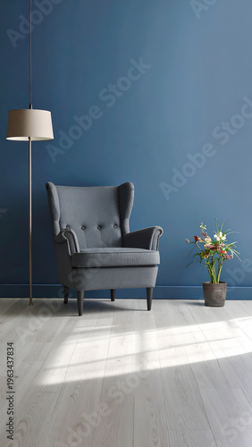 Blue wall, gray chair, flowers, floor lamp, sunny