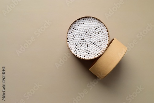 Slika na platnu Cardboard box with cotton swabs on a beige background
