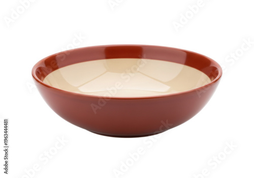 A shallow red bowl filled with creamy white soup or dessert