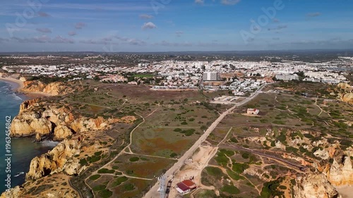 Aerial Pan Over Rugged Limestone Cliffs and Turquoise Sea at Ponta da Piedade Lagos Portugal