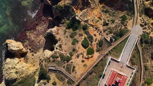 Aerial Top Down View of Ponta da Piedade Lighthouse and Rugged Algarve Cliffs in Lagos Portugal