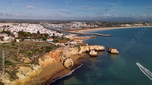 Aerial Orbit of Ponta da Piedade Cliffs Revealing Lagos City Skyline Algarve Portugal
