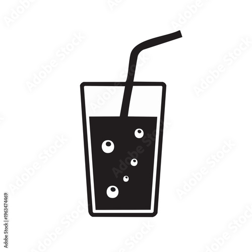 Dark beverage with bubbles in a clear glass with a straw for drinking refreshment