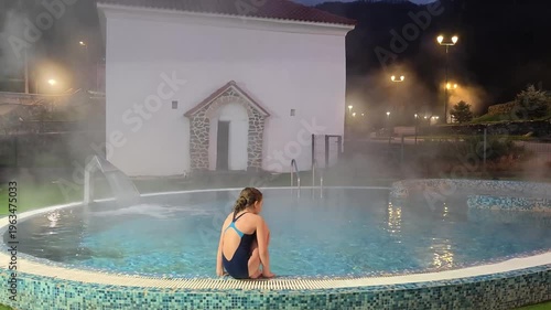The girl is in thermal springs, hydrogen sulfide springs and the concept of relaxation in the bath and recovery