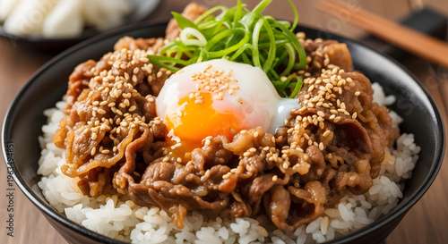 Japanese Gyudon beef bowl with soft boiled egg and green onions delicious Asian cuisine for restaurant menus and food blogs close-up shot