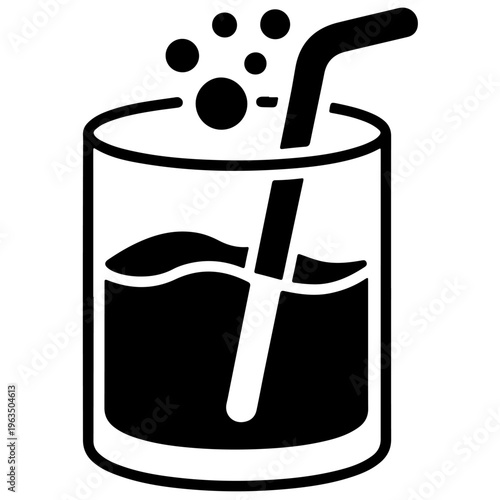 A glass of fizzy drink with a straw and ice cubes floating on top