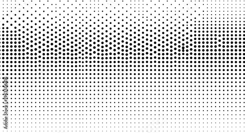 Halftone gradient texture with black and white dots, creating a smooth transition effect for design and artistic use.