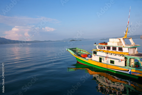 Konstfotografi Traditional fishing boat floating on calm indonesian sea