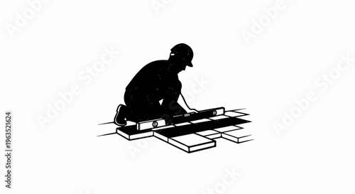 Silhouette of builder using level on floor tiles