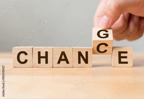 Fingers Flipping a Wooden Block to Change the Word 