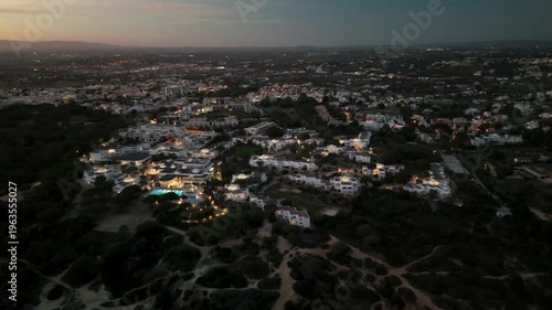 Aerial Drone Pull Back from Evaristo Town to Atlantic Ocean at Sunset Albufeira Algarve Portugal