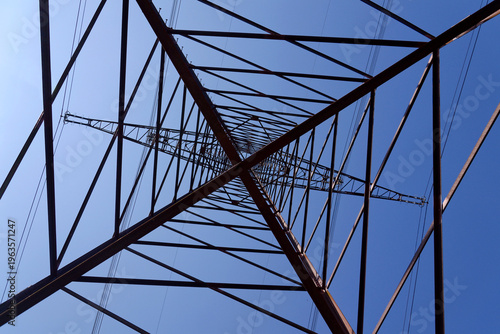 Electricity pylons conducting current from distribution power station, blackout and grid stability concept, copy space