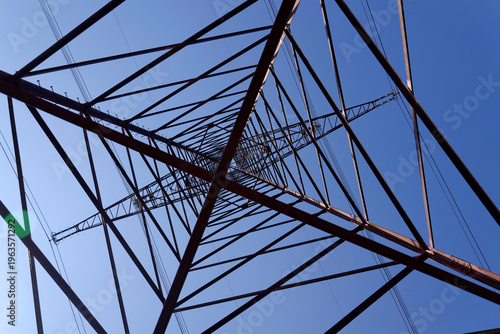 Electricity pylons conducting current from distribution power station, blackout and grid stability concept, copy space