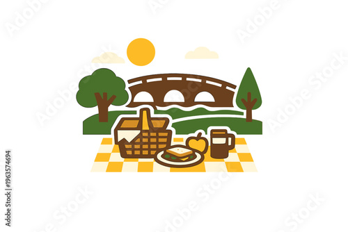 Picnic setup with food and drink near a bridge in a park on a sunny day