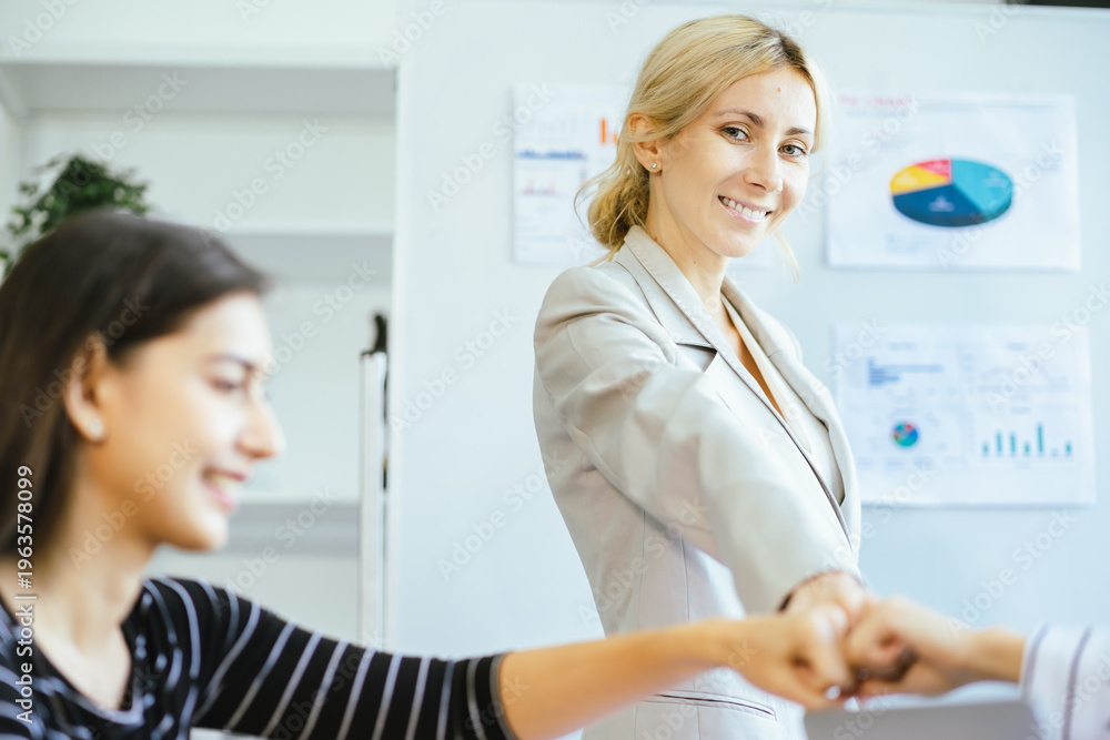 Fototapeta premium Business success plan win present team data global Two women present business data and global success plan to team using charts and graphs aiming to win with strategic analysis and teamwork