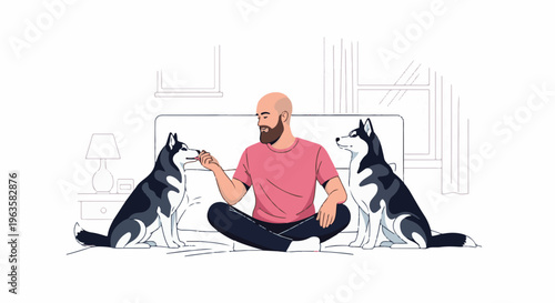 A man sits on a bed, feeding treats to two huskies, with a lamp nearby