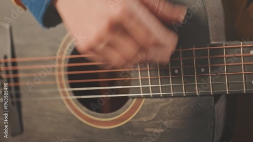 Guitar technique overview. Closeup on string plucking methods. Detailed view of fret hand movements and strum pattern. Intimate shot highlighting chord changes and finger positioning techniques