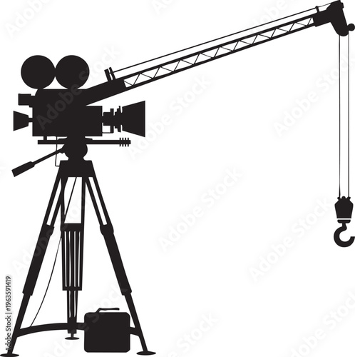 Film camera on crane arm in silhouette with industrial equipment for filmmaking