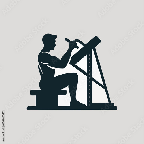 silhouette of man working on vintage lathe machine