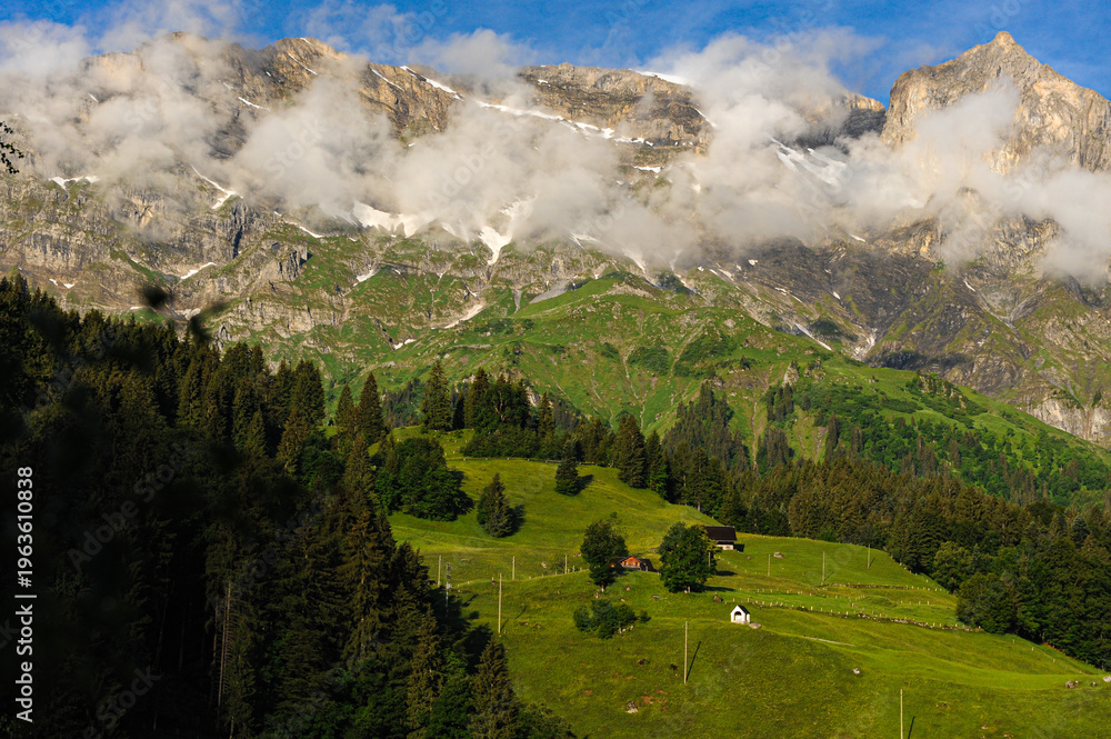 Fototapeta premium Majestic Alpine Peaks and Lush Green Slopes Above Engelberg Village 