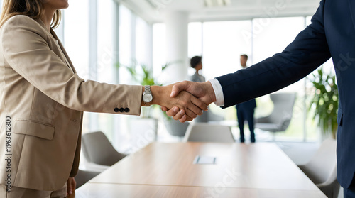 professional business handshake between man and woman in modern office board room representing successful deal partnership corporate recruitment and teamwork collaboration