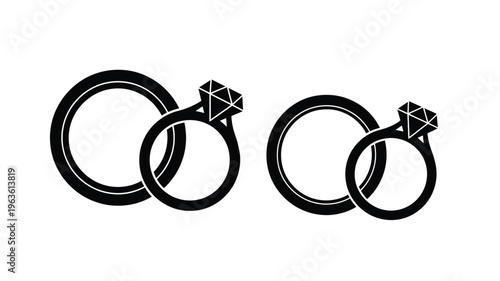 Two pairs of wedding rings displayed in a stark black silhouette