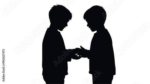Two young boys facing each other appearing to share something silhouette