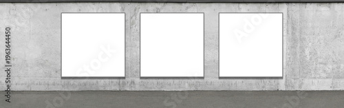Three large square white advertising billboards are located on the facade of a concrete fence, intended for creative use. Presentation space. Advertising space.