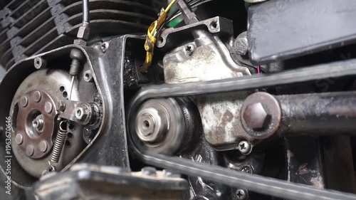 magnetic wheel in the machine with a counterweight hole, a lever mechanism connected by a pull spring and a steel cable, all inside a metal housing made of oily looking material