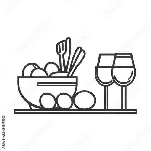 A bowl of food with serving utensils and wine glasses