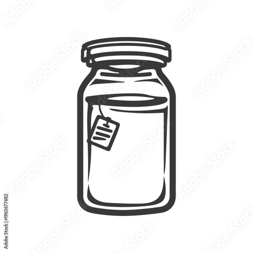 A glass jar containing liquid with a tea bag visible inside