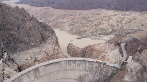 Low water level at Vidraru Dam in the Carpathian Mountains on a cloudy day