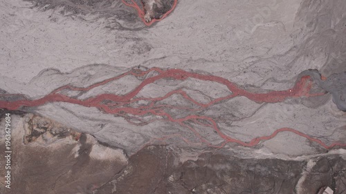 Abstract textures on the drained reservoir floor at Vidraru Dam with mineral patterns and sediment layers