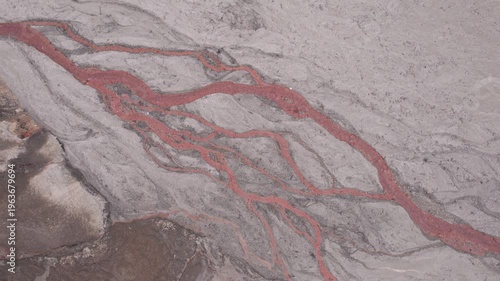 Abstract textures on the drained reservoir floor at Vidraru Dam with mineral patterns and sediment layers