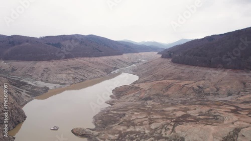 Aerial landscape of the drained Vidraru reservoir in the Carpathian Mountains	