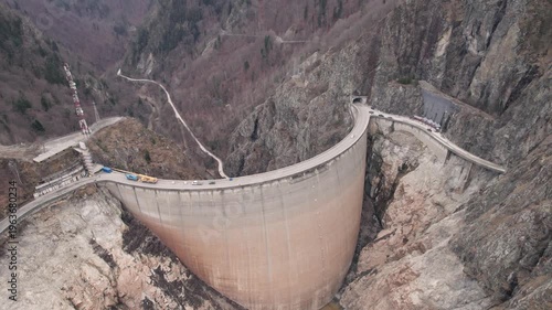 Low water level at Vidraru Dam in the Carpathian Mountains, on a cloudy day