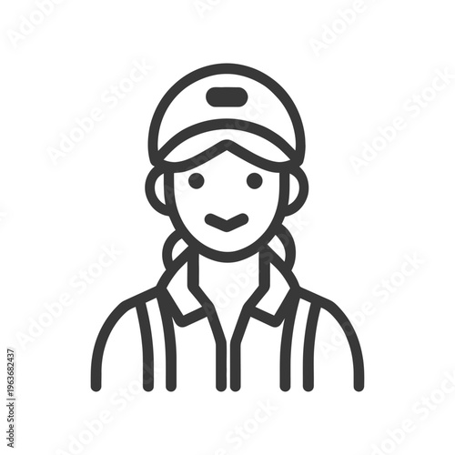 A female worker in a cap is smiling at the viewer