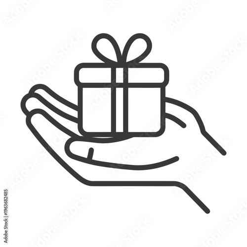 A hand holding a gift box with a decorative bow on top