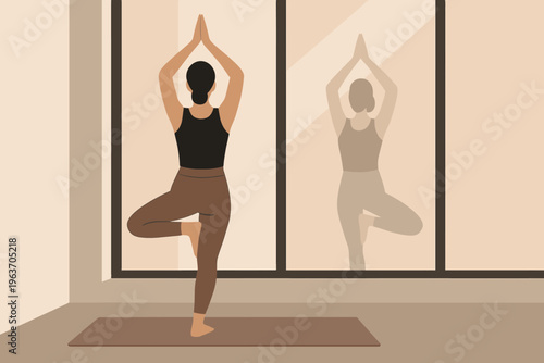 Woman practicing tree pose yoga indoors with reflection in window