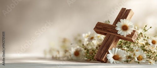 Wooden cross with daisies on soft background for Easter