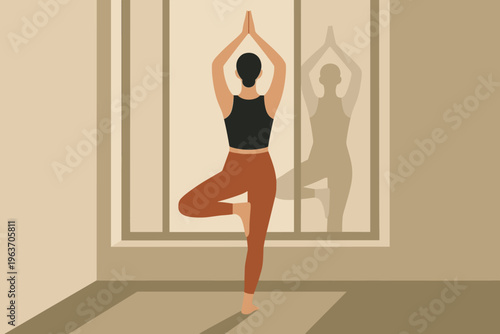Woman practicing Vrikshasana yoga pose in a minimalist room with natural light
