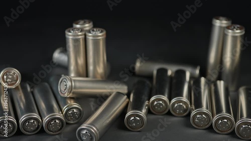 Silver AA batteries type on black matte background as an example of rare earths metals use in magnets, smart devices, electric vehicles and are hard to mine and separate cleanly.