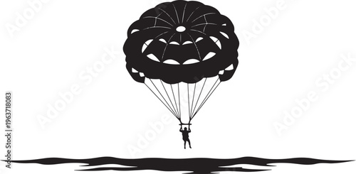 Parasailer suspended mid-air above calm water, enjoying a thrilling aerial adventure over the ocean during a sunny day.