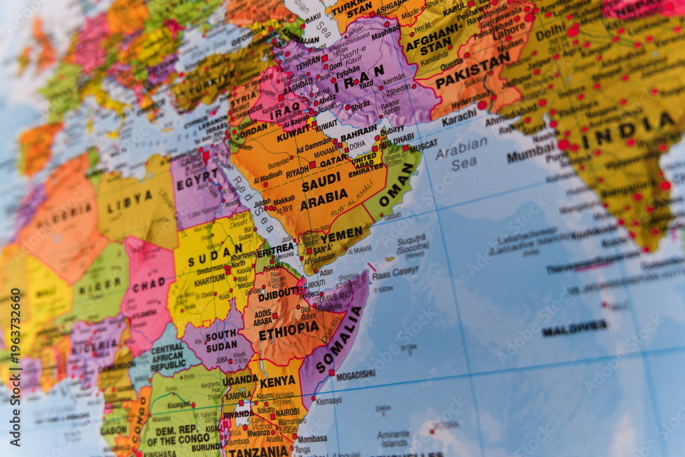 Obraz premium A vivid, highly detailed colorful political map with selective focus showing the Middle East, Arabian Peninsula, and East Africa. 