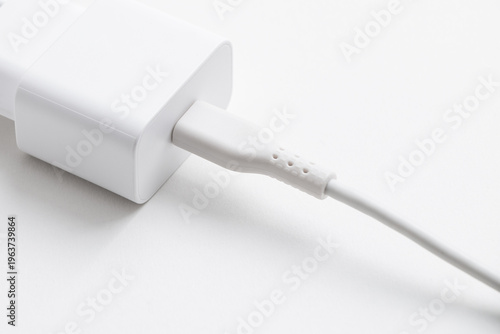 Power adapter with charging cable isolated on white background