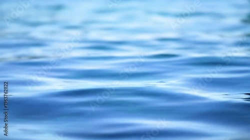 Wallpaper Mural Close-up video of serene, clear blue water surface with gentle ripples, shimmering light, and a natural blue gradient. Soft daylight tracking video; meditative abstract background Torontodigital.ca