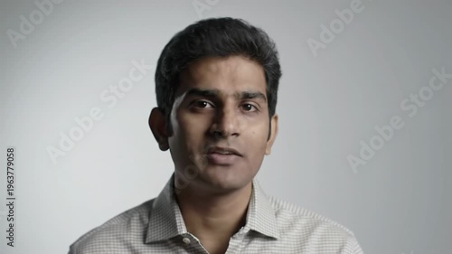 Wallpaper Mural Diverse professional, 30s-40s, in business-casual, subtly smiles with serene focus against a creamy bokeh studio background. Slow push-in video with copy space. Concept of visionary thinking Torontodigital.ca